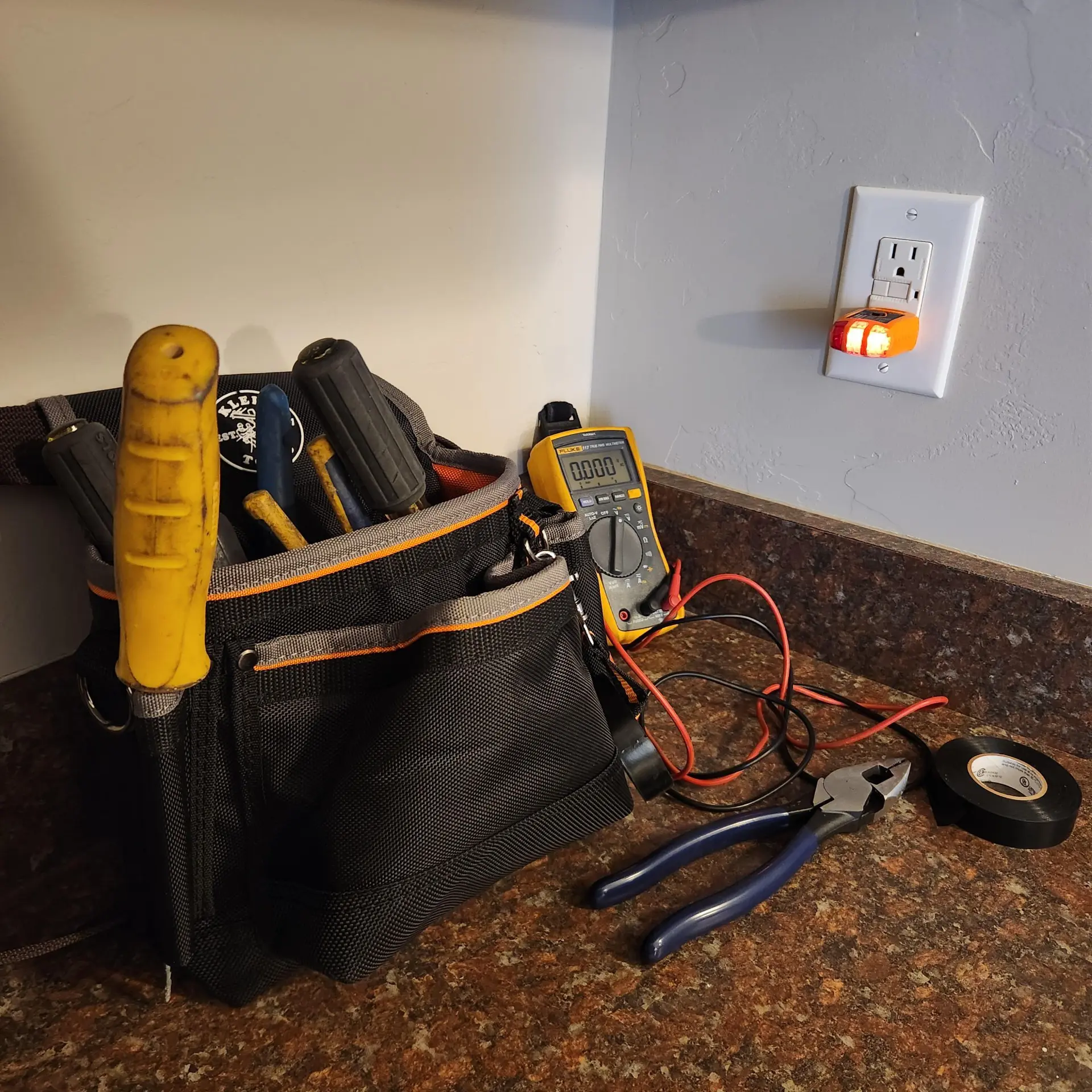 Tool bag with multimeter and outlet tester