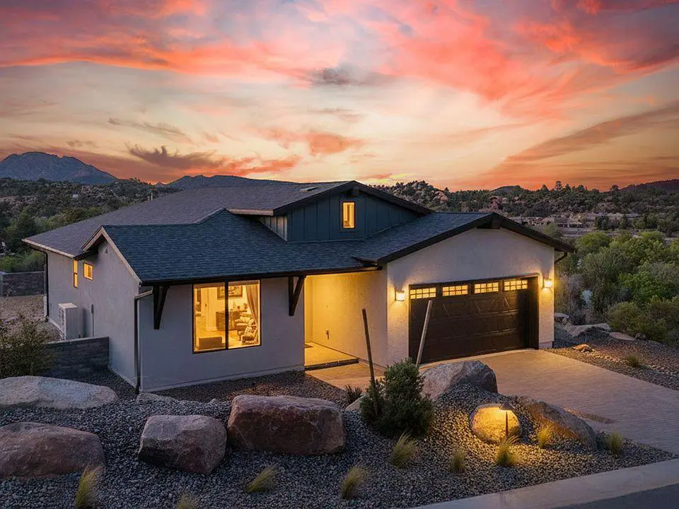 Modern desert home at sunset with lights